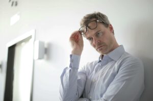 photo of man leaning on wall