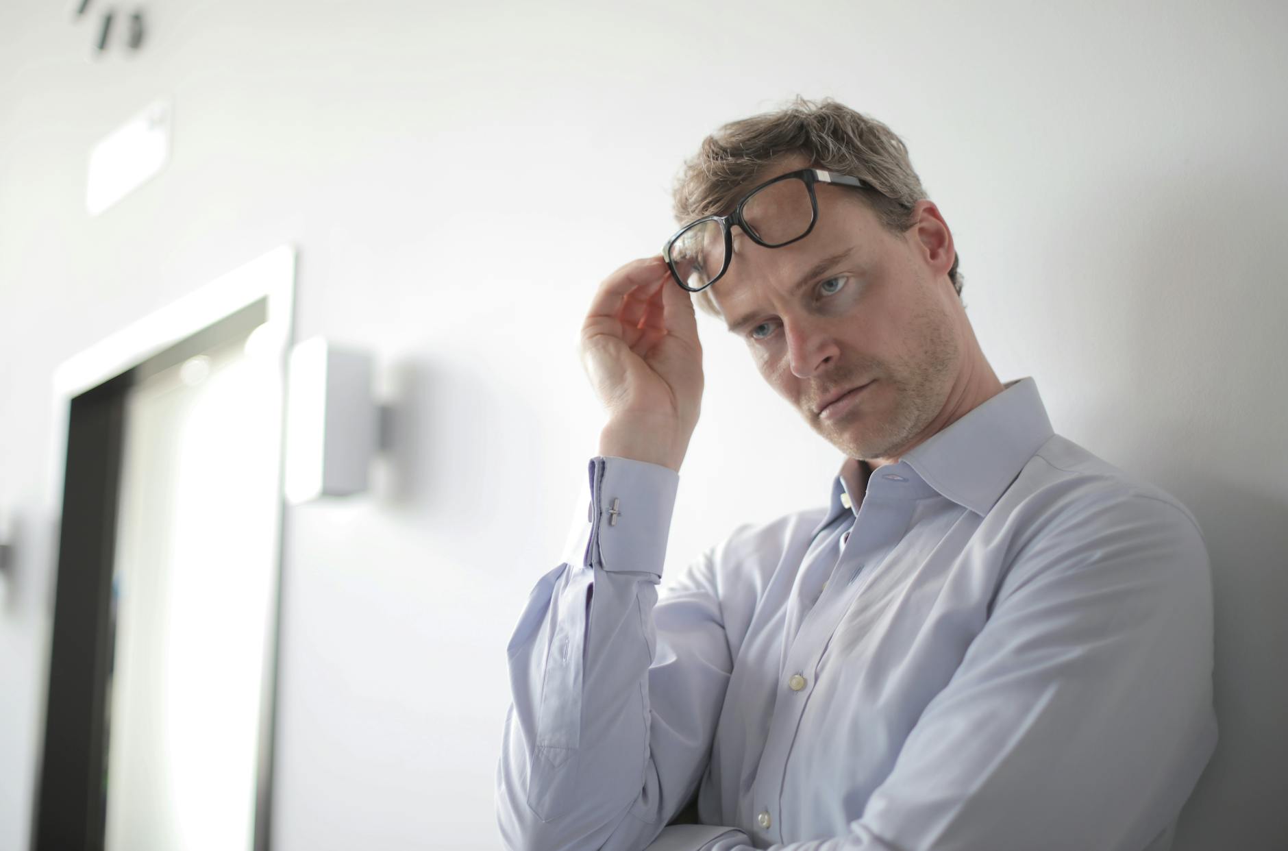 photo of man leaning on wall